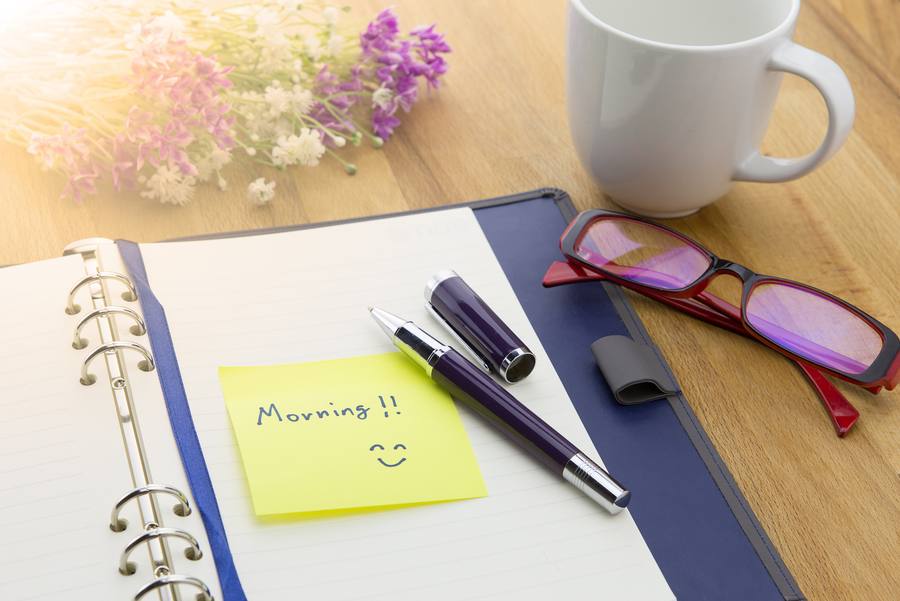 A pen resting on an open notebook