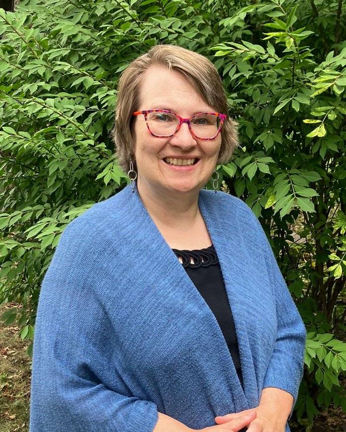Cindy Hodgson, smiling, outdoors in summer daylight